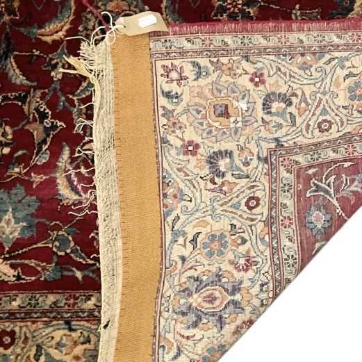 A Persian style hand woven silk red ground floral decorated carpet, with central red ground - Image 2 of 2