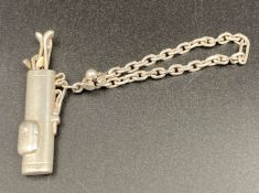 A novelty white metal golf bag, button hole/ key chain,