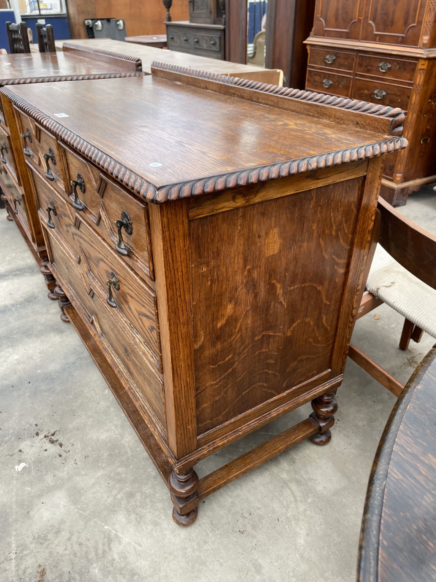 AN EARLY 20TH CENTURY OAK JACOBEAN STYLE CHEST OF TWO SHORT AND TWO ...