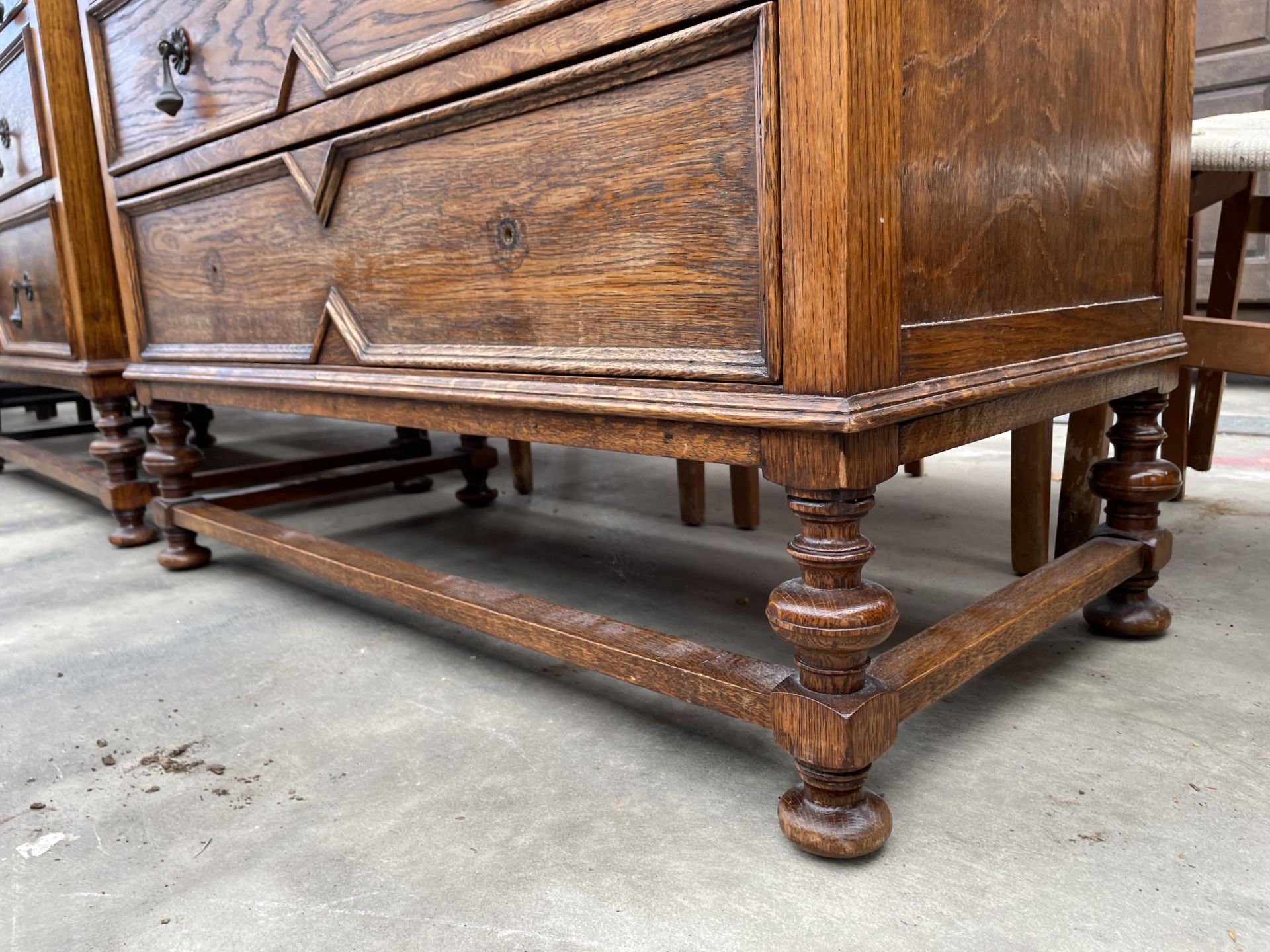 AN EARLY 20TH CENTURY OAK JACOBEAN STYLE CHEST OF TWO SHORT AND TWO ...