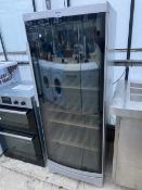 A LARGE SILVER AND BLACK GLASS BOSCH BOTTLE FRIDGE