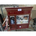 A WOODEN CHINA SHOP DISPLAY UNIT