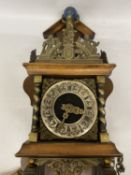 A CHARLES ATLAS WALL CLOCK WITH WEIGHTS