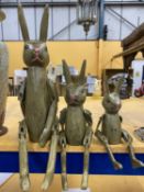 THREE GRADUATED ARTICULATED TREEN RABBITS