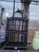 A DECORATIVE WOODEN BIRD CAGE