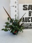 ONE CHRISTMAS TABLE ARRANGEMENT TO INCLUDE EUCALYPTUS, HOLLY, SNOWBERRY, BERRIES AND PHEASANT