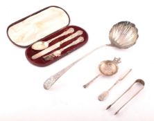 A group of assorted silver items, including a Georgian silver ladle with round shell bowl, old