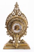 A round decorative brass mantel clock the eight-day duration movement striking the hours and