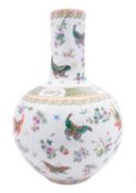 A Chinese porcelain bottle vase painted in famille rose enamels with butterflies amongst prunus,
