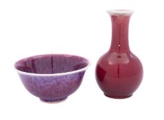 A small Chinese sang-de-boeuf baluster vase and a similar flambe bowl,