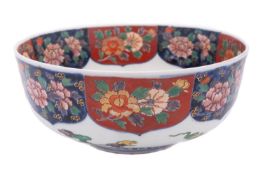 A Japanese Arita porcelain bowl the interior painted with a pair of horses and three boys in a
