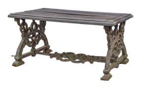 A cast iron and wood slatted garden or conservatory table, in Aesthetic taste,