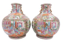 A pair of large Chinese Canton famille rose vases of squat globular form with waisted necks applied