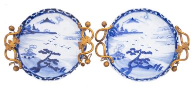 A pair of Chinese porcelain plates mounted as comports,