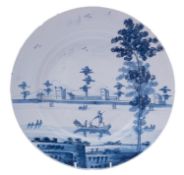 A Bristol blue and white delftware dish painted with a large country mansion with sponged trees