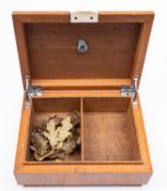 A Regency walnut and banded tea caddy, circa 1815; of sarcophagus form, 16cm high,