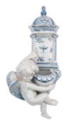 A Cantagalli pottery holy water stoop of traditional form and supported by a putto, painted in blue,