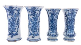 Two pairs of Dutch delft ware vases of waisted octagonal form with raised strap work and painted