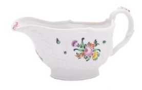 A Champion's Bristol sauceboat moulded with swags of flowers and foliage, the rim with scrollwork,