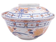 A large Japanese Imari bowl and cover painted overall with flower sprays and bands of geometric