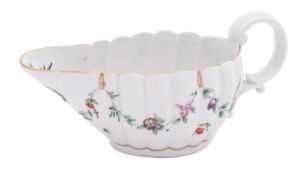 A Champion's Bristol lobed oval sauceboat monogrammed 'REG' in gilt within a leafy roundel,