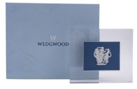 A Wedgwood dark blue jasper ware plaque sprigged in white with the Three Graces, 9 x 12cm,