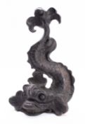 A Victorian iron door porter cast as a dolphin,