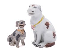 An Arita-style porcelain figure of a hound and a similar smaller figure decorated with brown and