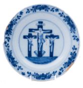 A Dutch delftware crucifixion plate, 18th century painted in blue and iron-red,