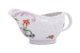 A Champion's Bristol butterboat moulded with bunches of fruit and painted with a loose bouquet and