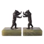 A pair of onyx mounted metal bookends in the form of standing bears, in Art Deco taste,