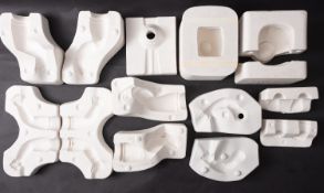 A collection of various plaster doll mou