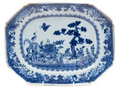 A Chinese porcelain meat plate of octagonal form painted in blue with a pair of cranes in a garden