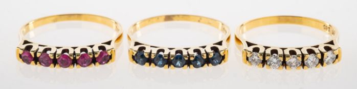 A group of three stacking rings, including a ring set with five brilliant-cut diamonds,