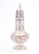 A George V silver sugar caster by Goldsmiths & Silversmiths Co Ltd, London 1912, of baluster form,