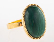 A malachite set ring, set with an oval malachite cabochon, Foreign marks to outside of shank,