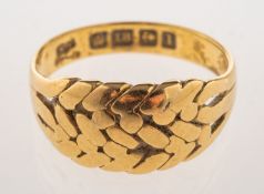 An early 20th century 18ct gold keeper ring, of woven design, UK hallmark, Birmingham, 1910,