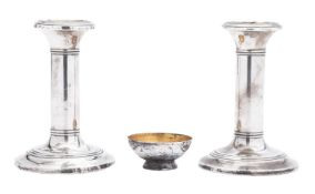 A pair of Edwardian silver candlesticks, with reeded borders,