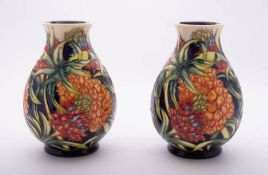 A pair of Moorcroft limited edition pottery vases of oviform tube lined in the Pineapple pattern