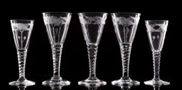 A part suite of drinking glasses the conical shaped bowls engraved with four seed heads on a