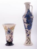 A Moorcroft pottery ewer of slender baluster form tube lined in the Delphinium pattern after a