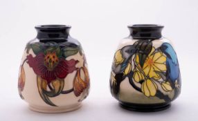 Two Moorcroft pottery vases of barrel shaped form comprising a limited edition vase tube lined in
