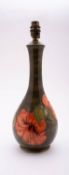 A Walter Moorcroft pottery lamp of slender baluster form tube lined in the Hibiscus pattern on an