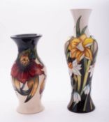 Two Moorcroft pottery vases comprising a limited edition slender baluster vase tube lined in the