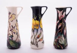 Three Moorcroft pottery ewers of tapering form tube lined respectively in the Lemon Sorbet,