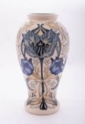 A Moorcroft pottery vase of baluster form tube lined in the Garden Tulip pattern after a design by