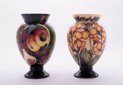 Two Moorcroft pottery vases of footed oviform comprising a limited edition vase tube lined in the