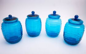 Four blue glass mould blown storage jars.and covers, 26cm high.