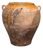 A Continental partially glazed terracotta jar, 20th century; of ribbed ovoid form,