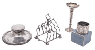 A small mixed lot of silver, comprising of an inkwell (loaded base), inscribed, a toast rack,